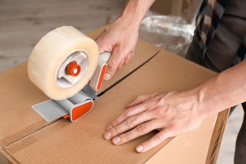Packing Young man packing moving box indoors, closeup in Benfleet & Southend-on-Sea